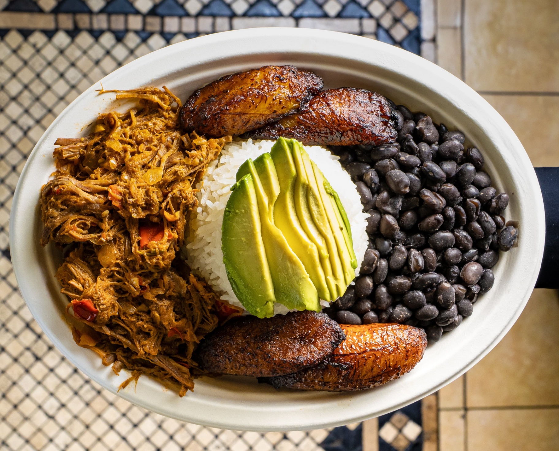 Traditional Pabellón — shredded beef, rice, beans, plantains.